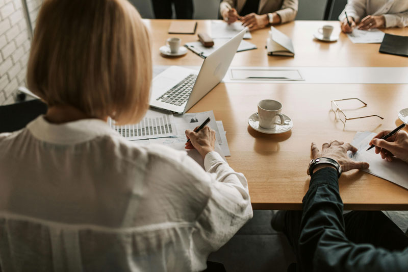Back of woman's head sitting at a conference table