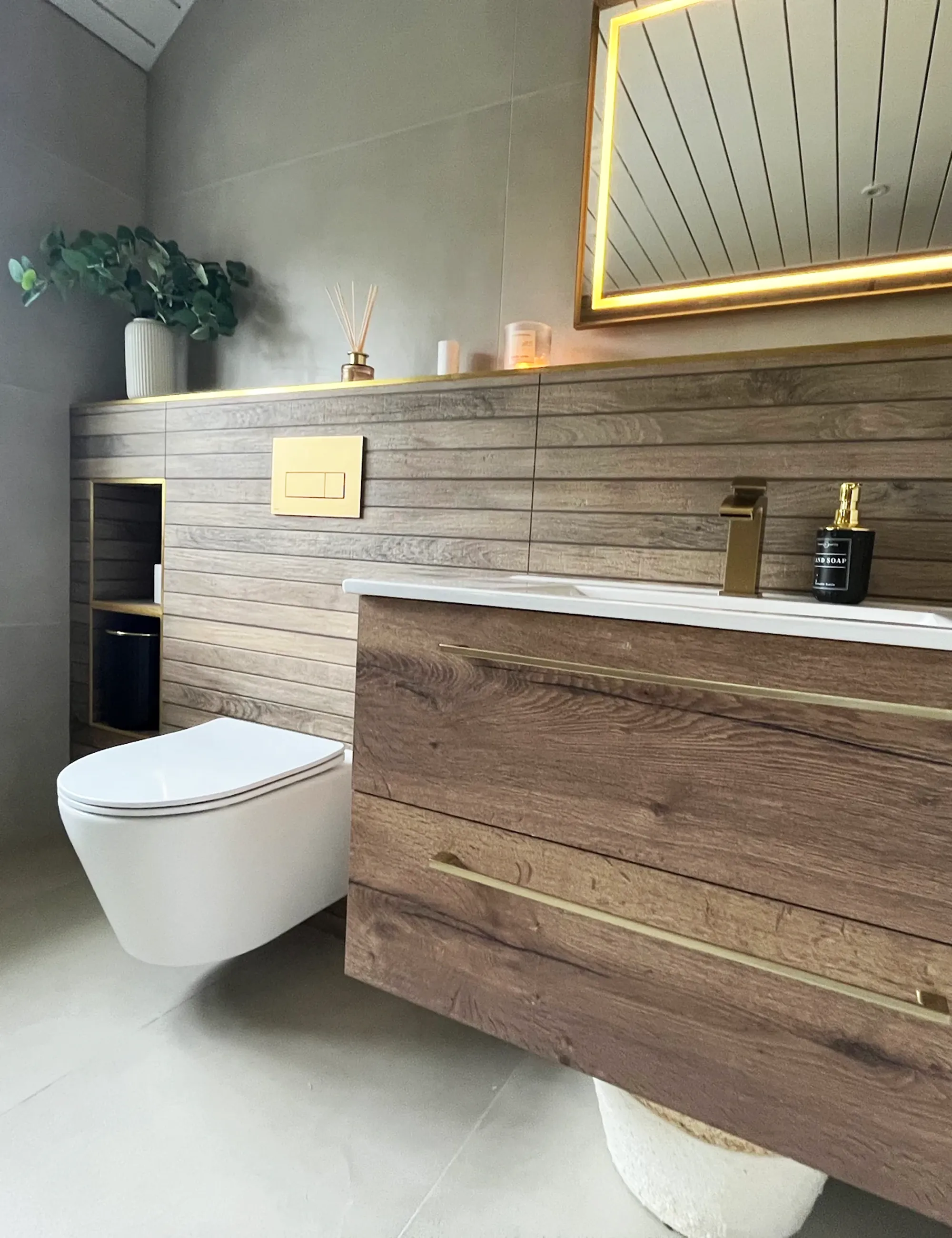 Luxury bathroom renovation with wooden vanity and wall mounted toilet