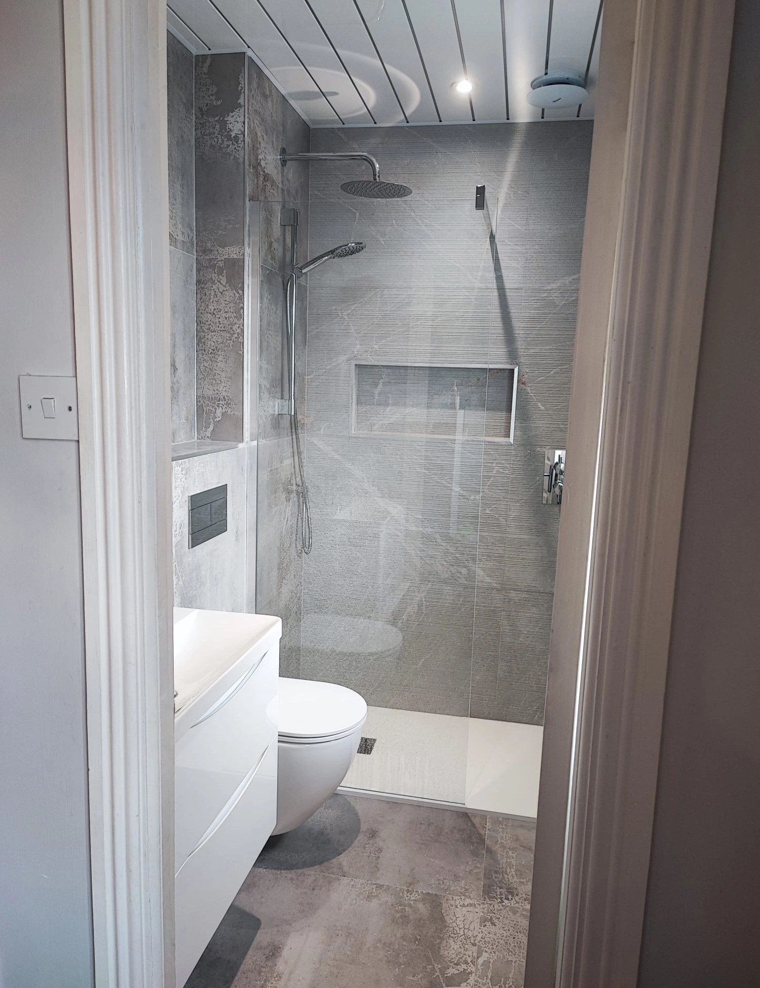 Walk in shower bathroom renovation with glass screen and grey tiles Ireland