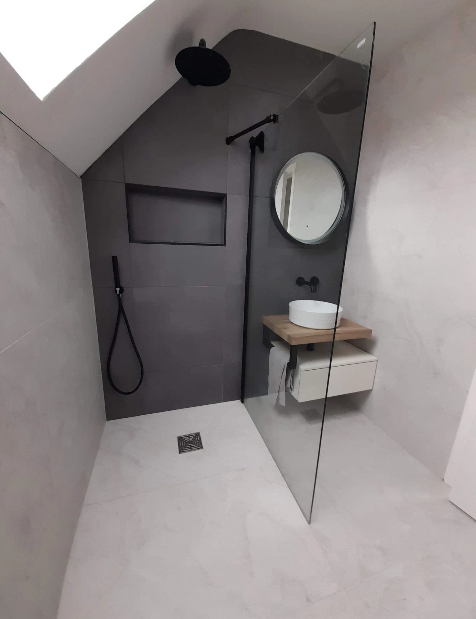 Wet room installation with walk in shower and glass screen