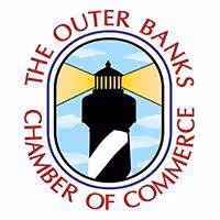 Logo of The Outer Banks Chamber of Commerce featuring a lighthouse with black and white diagonal stripes against a blue sky and yellow light beams.
