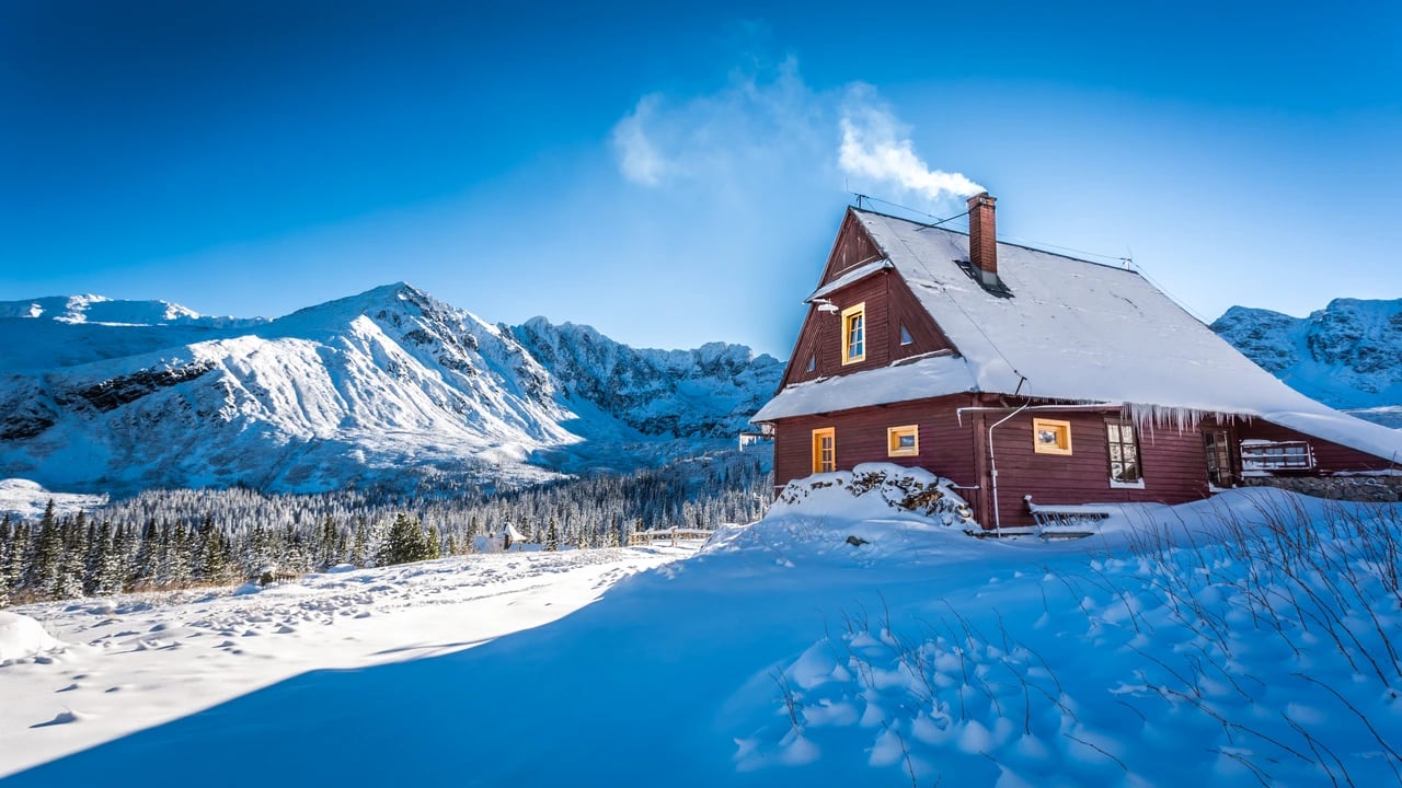 Cozy cabin in the snowy mountains, representing professional vacation rental cleaning and turnover services.