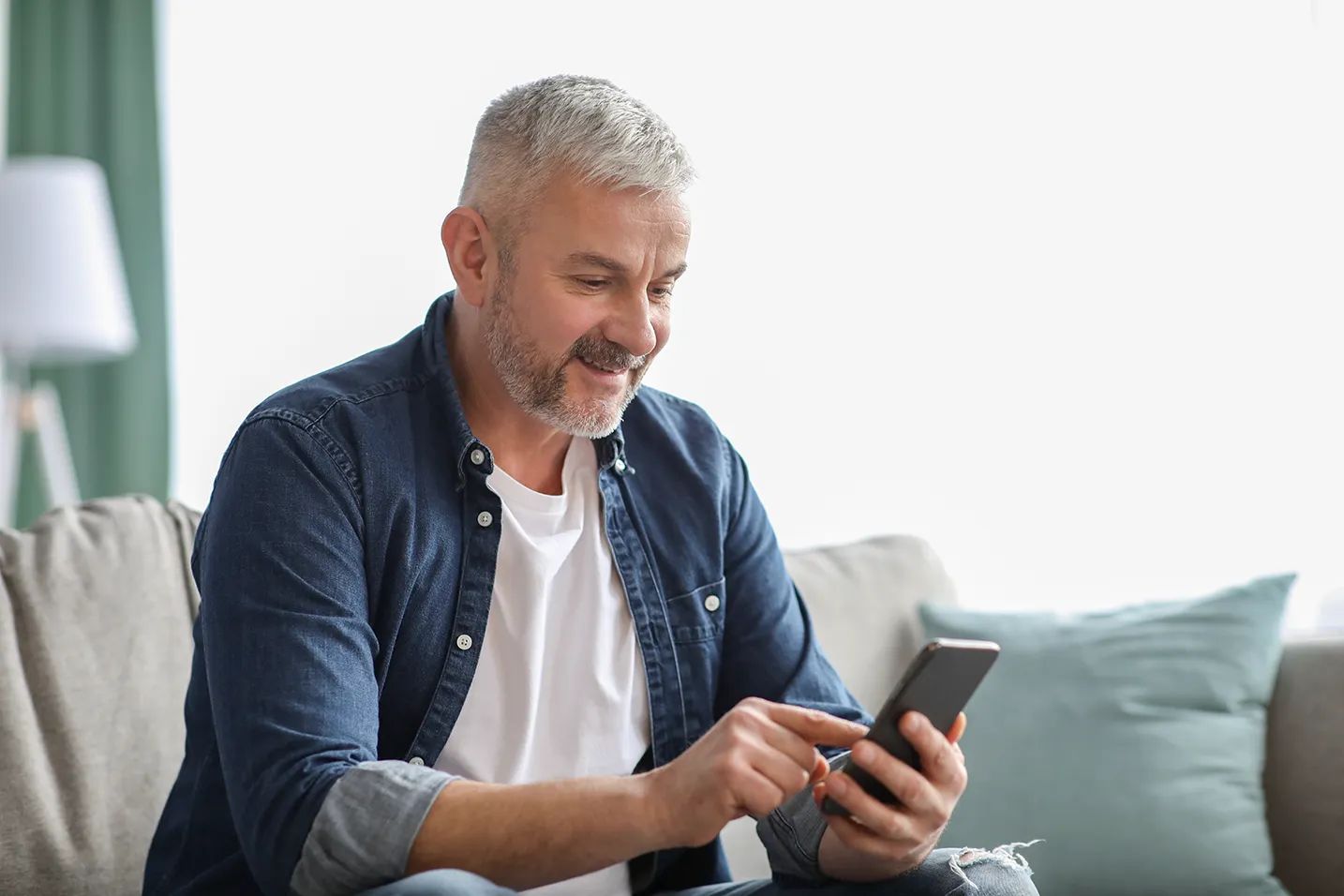 a customer scheduling services on his phone at home.