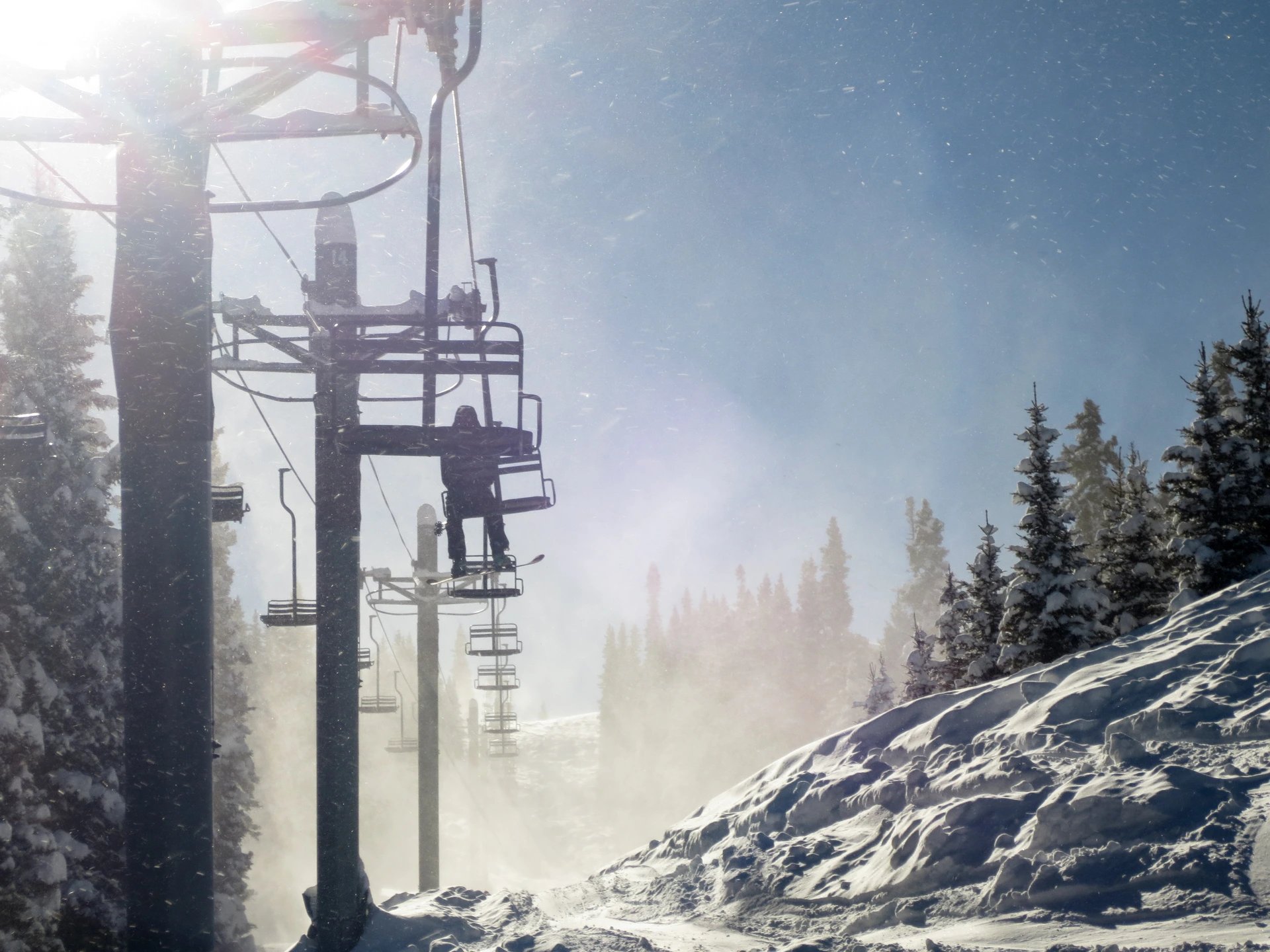 Snow-covered ski lift in Durango, Colorado on a sunny winter day, representing Lucky Services’ seasonal support and home care during the ski season.