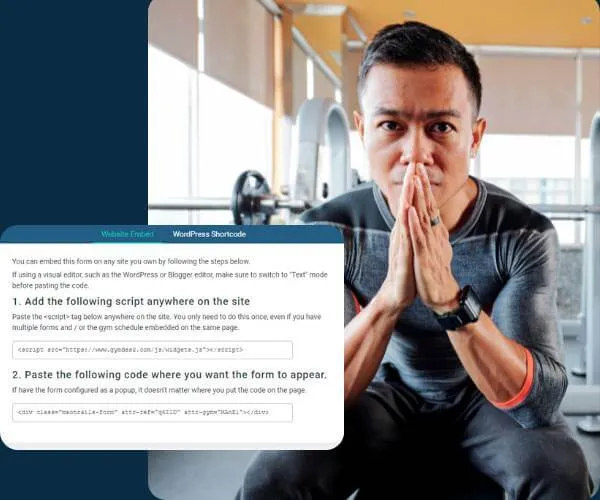 Man in athletic wear sitting and looking thoughtfully with hands pressed together in a gym setting.