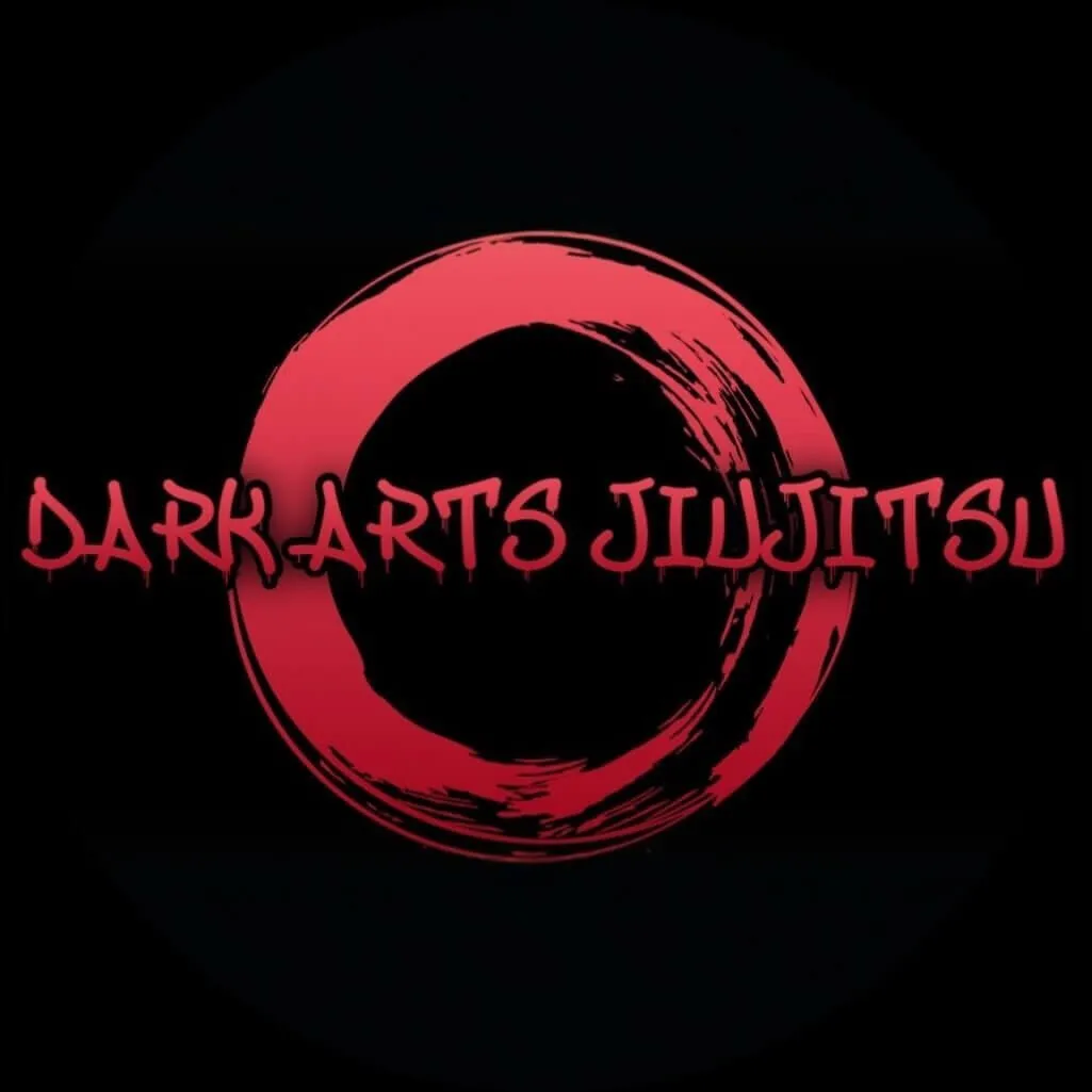 Red brushstroke circle with the text 'Dark Arts Jiujitsu' in stylized red font on black background.