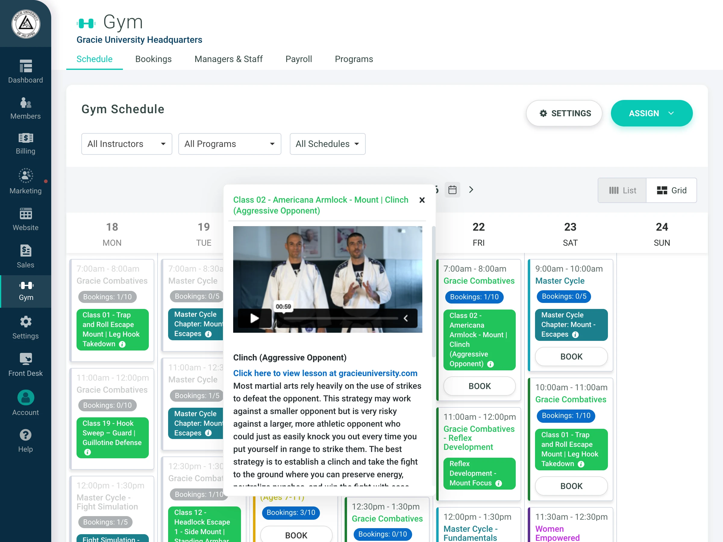 Gym schedule interface showing classes, bookings, and lesson details for Gracie University Headquarters.