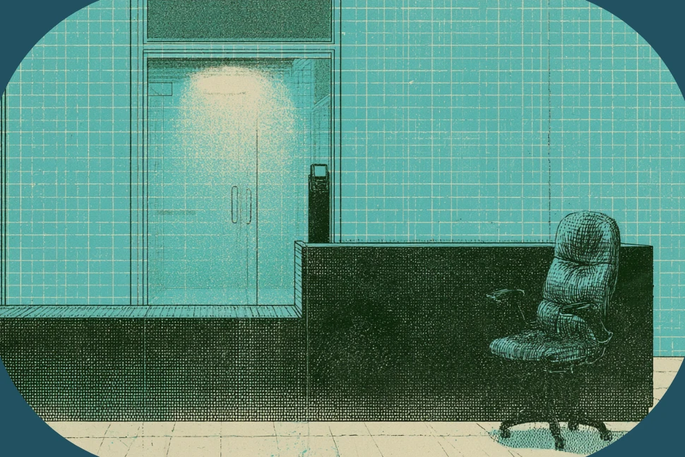 An empty gym reception desk at night with the entry doors access reader glowing, standing in for the front desk during unstaffed hours.