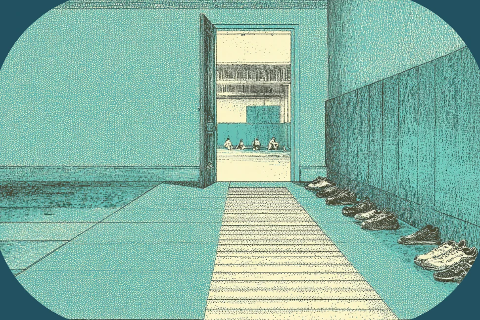 The entryway of a jiu-jitsu academy, shoes lined along the wall with one visible gap in the row