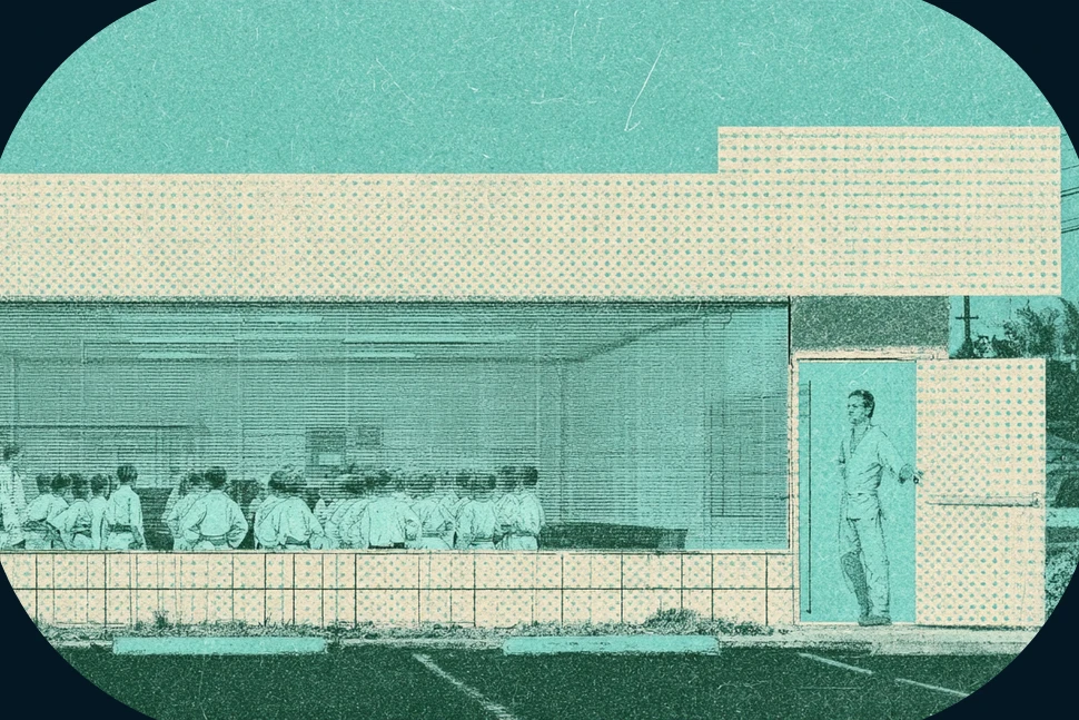 Martial arts instructor holding open the door of a small dojo while a class of kids in white uniforms lines up inside