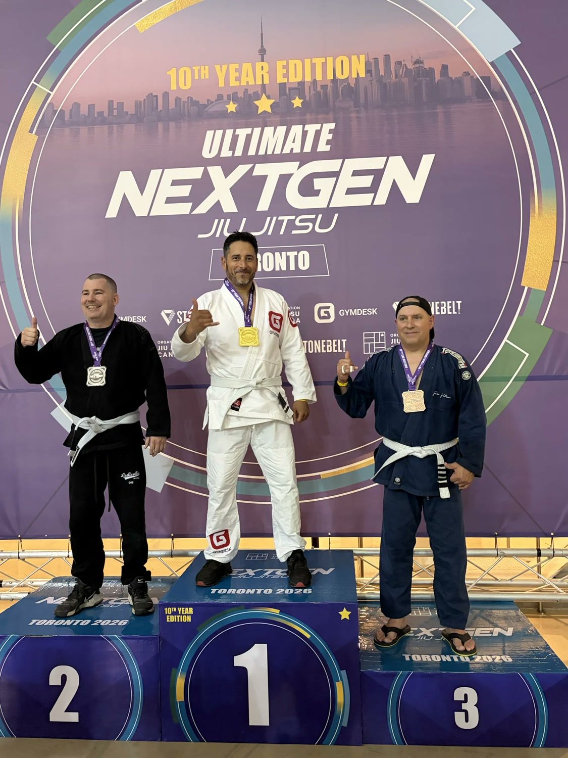 Alex Cuevas on top of the podium with a gold medal at Ultimate NextGen Jiu Jitsu in Toronto