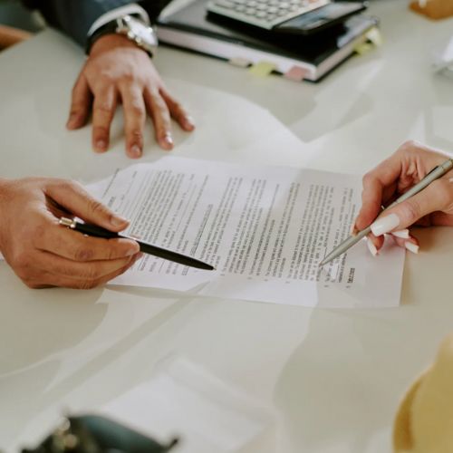 Agent reviewing income verification paperwork with client.