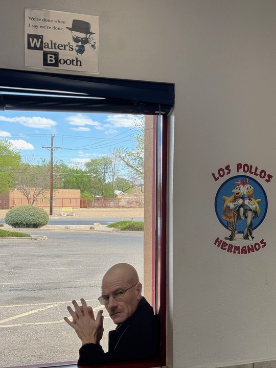 Breaking Bad scene parody with Walter White outside Los Pollos Hermanos window under a sign reading Walter’s Booth.
