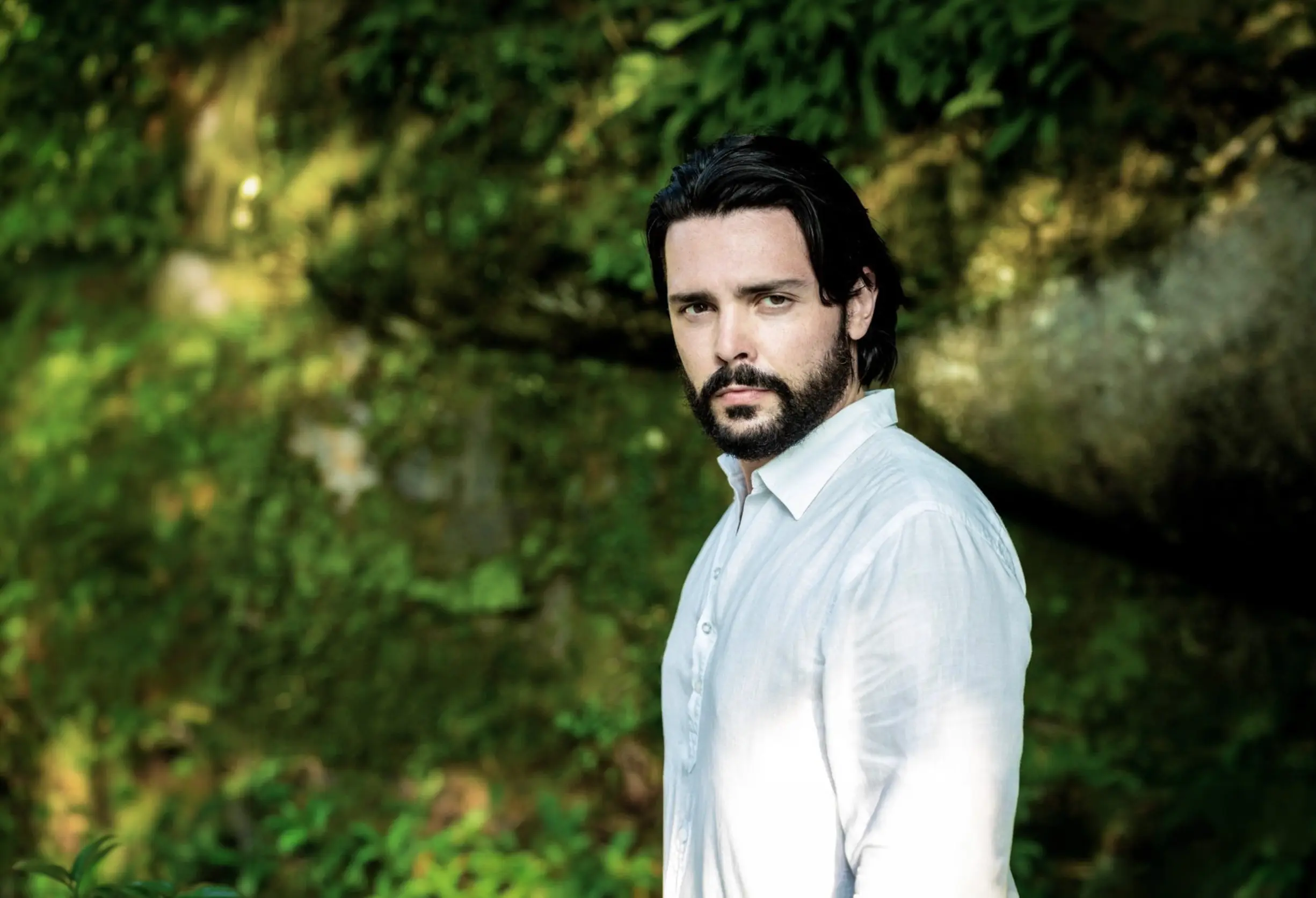 Image of Luca Micheletti photographed outside surrounded by greenery