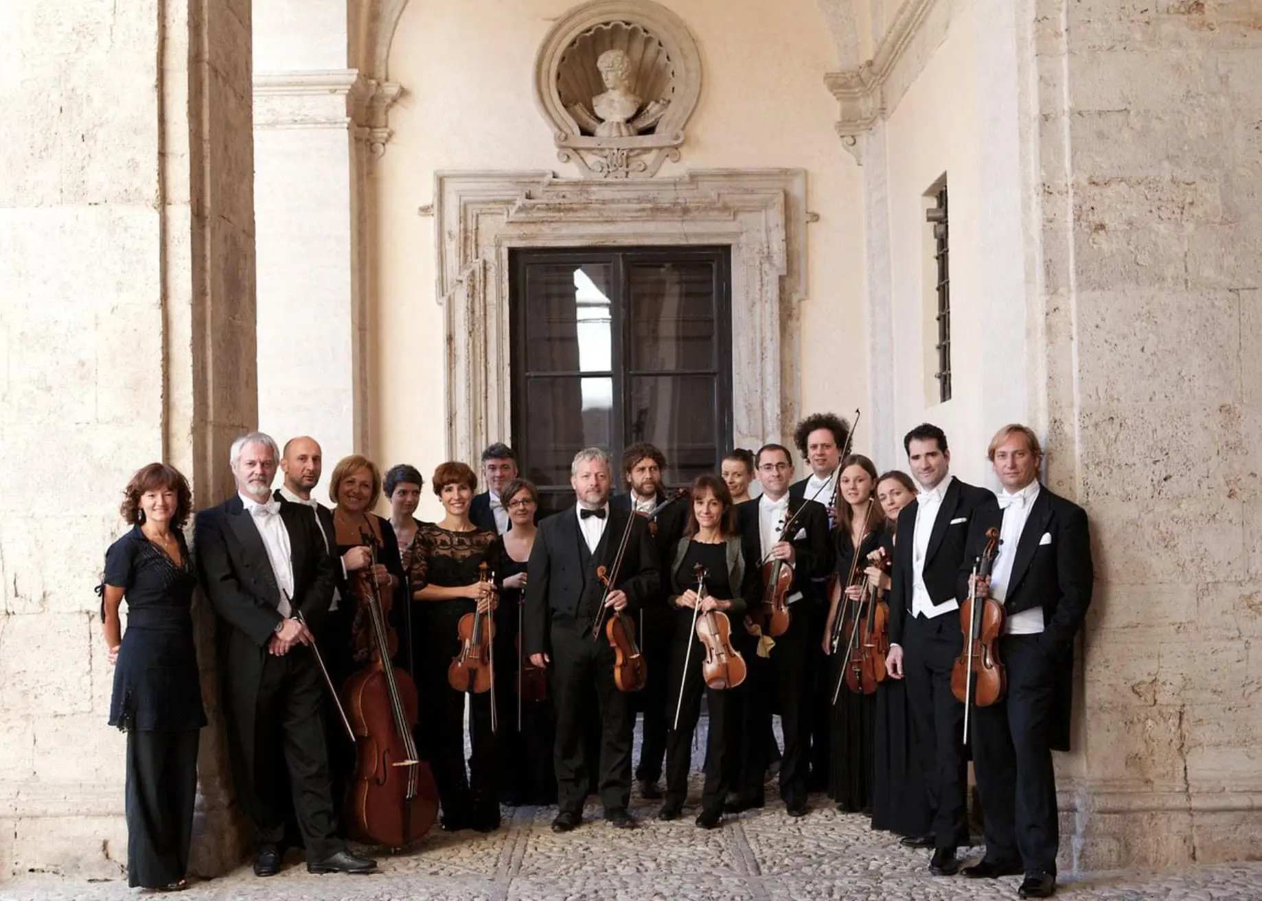 Image of ensemble Europa Galante photographers outside by a historic building