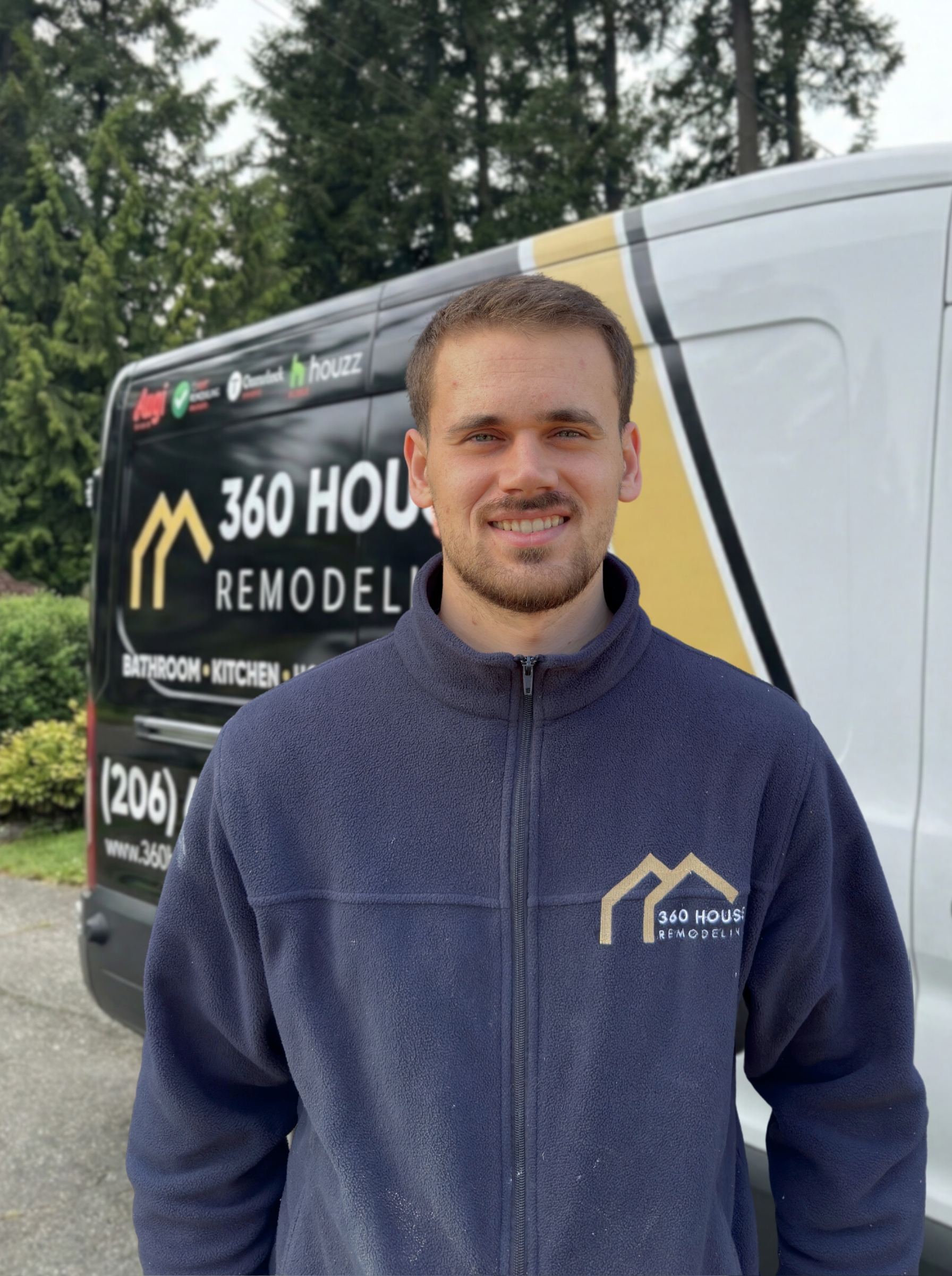 Smiling man wearing a navy fleece jacket with 360 House Remodeling logo standing in front of a company van.