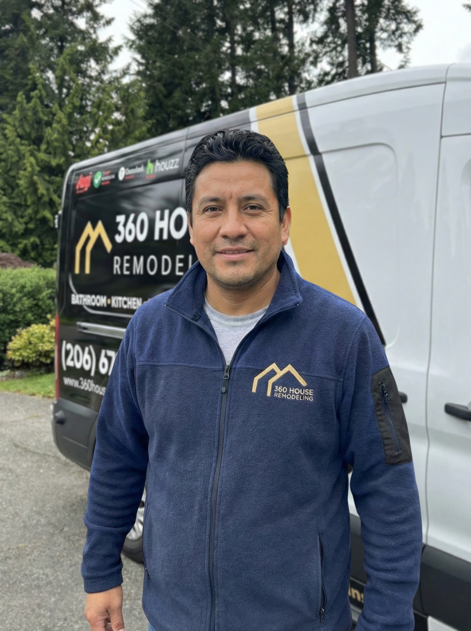 Man in navy blue fleece jacket with 360 House Remodeling logo standing in front of company van.
