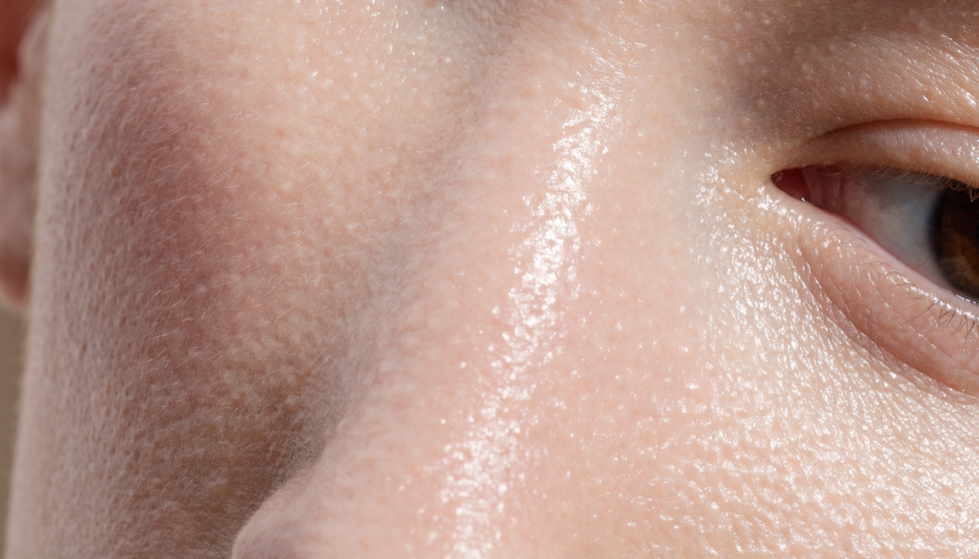 Close up of healthy hydrated facial skin showing natural texture, fine pores and a dewy glow