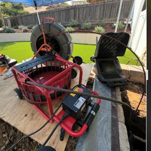 Sewer inspection camera and reel equipment set up for underground pipe diagnostics.