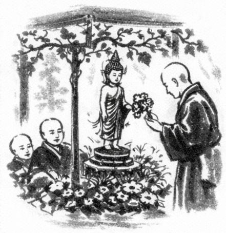 Monks performing a flower offering ceremony to a standing Buddha statue under a canopy decorated with vines.