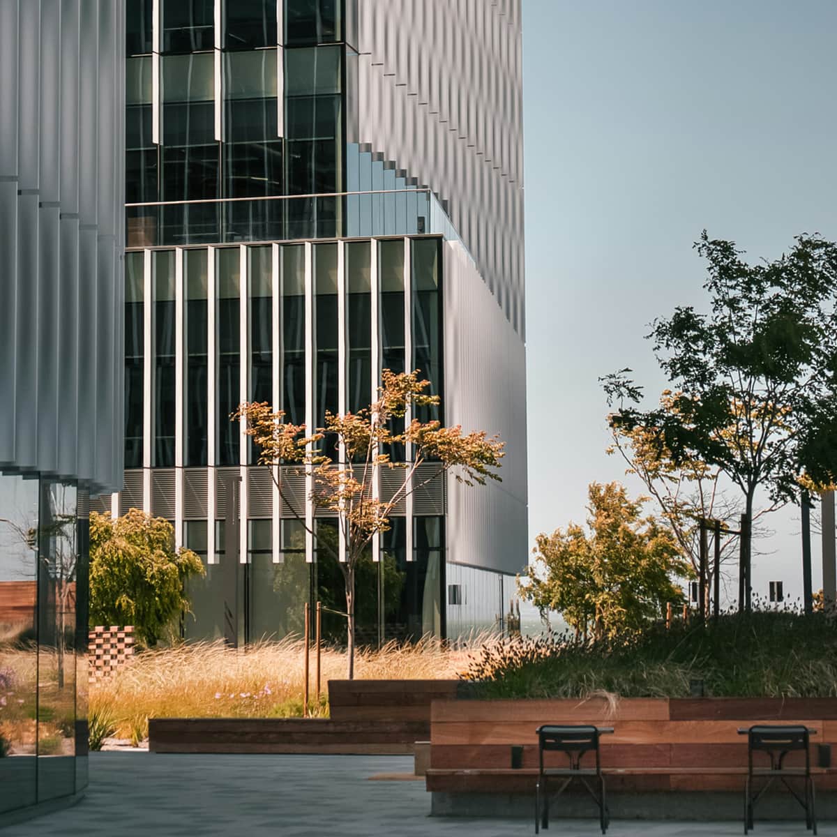 A photo of a recreational coffee break area beside a modern office building.