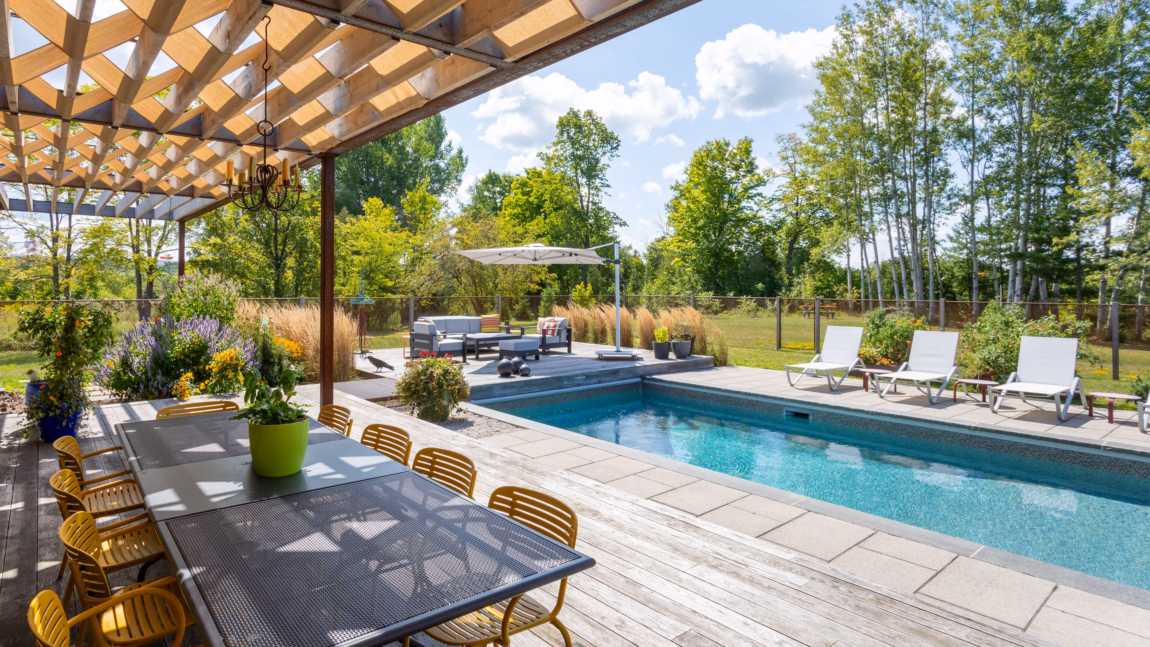 backyard landscaping with pool featureing waterfalls flowing into the pool, cabana with fireplace