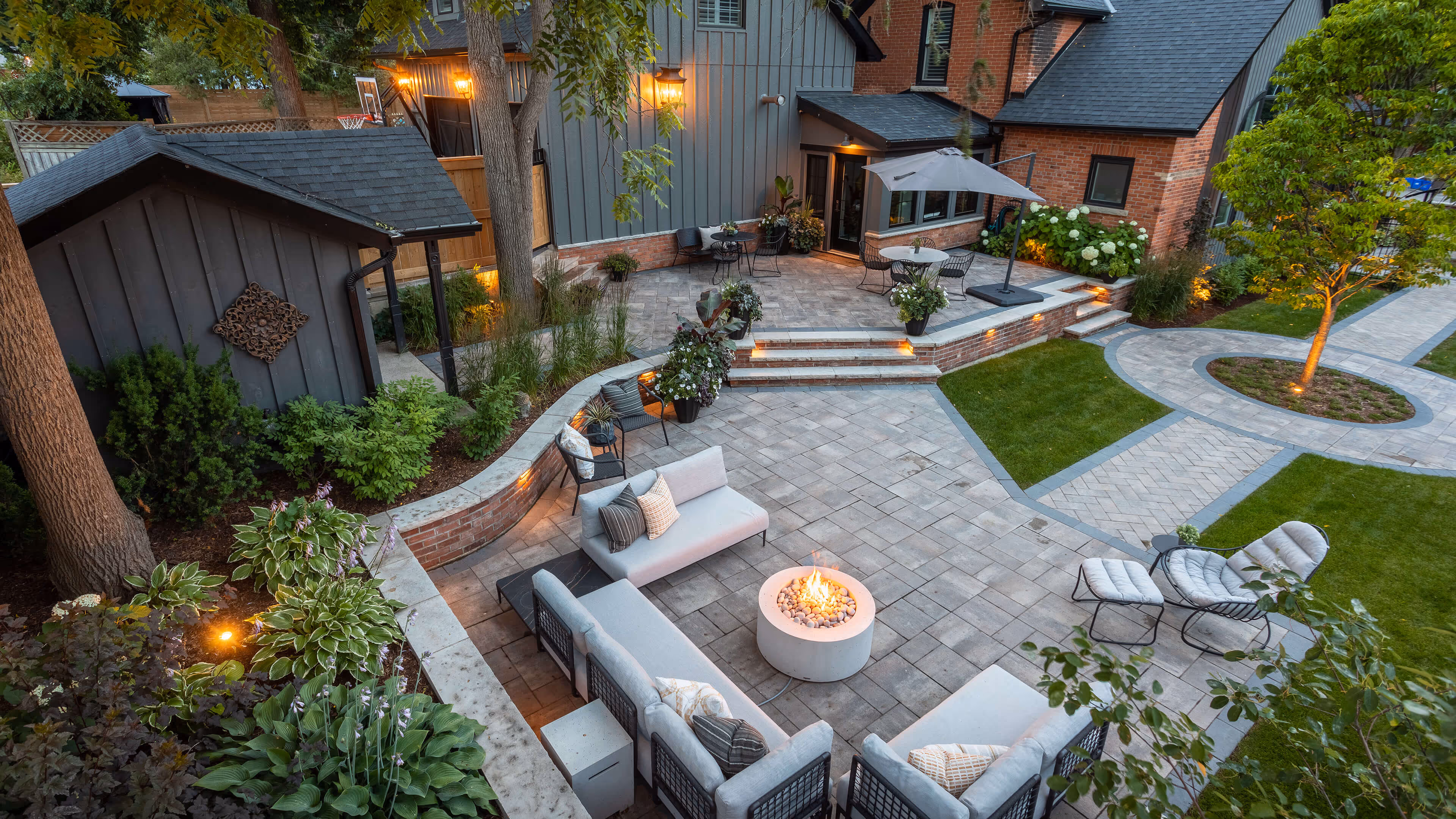 backyard landscaping with pool featureing waterfalls flowing into the pool, cabana with fireplace