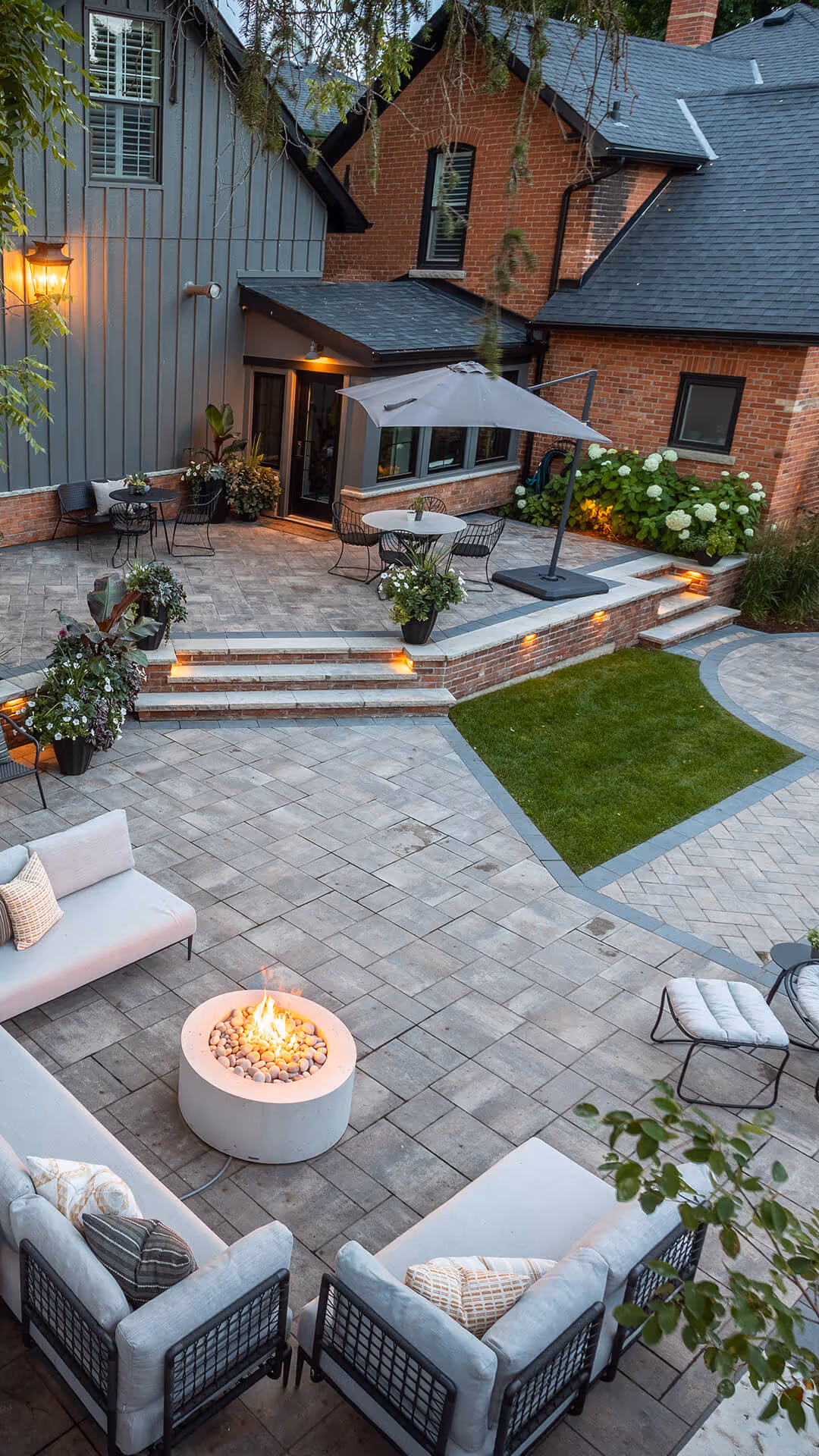 backyard landscaping with pool featureing waterfalls flowing into the pool, cabana with fireplace
