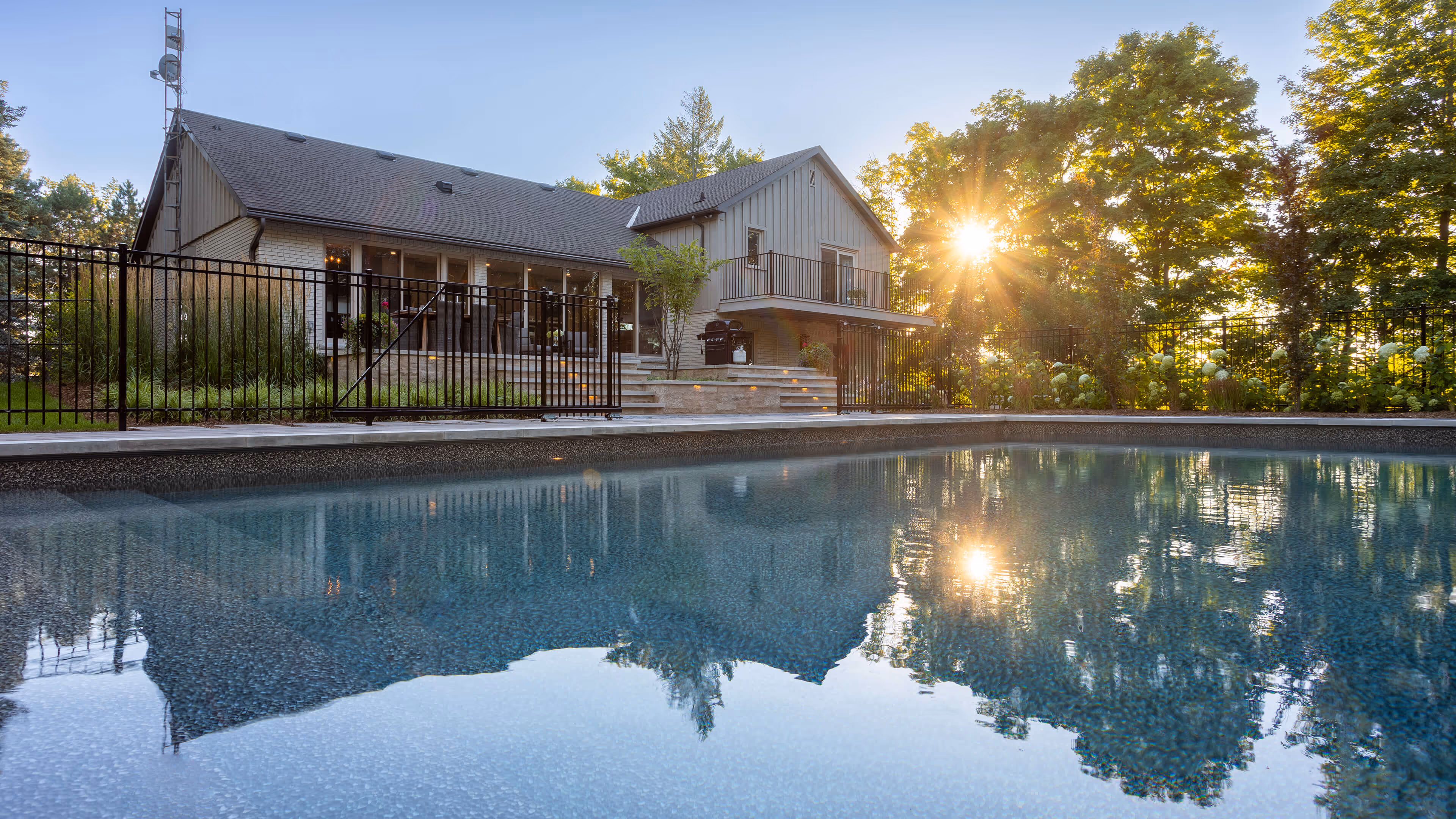 backyard landscaping with pool featureing waterfalls flowing into the pool, cabana with fireplace