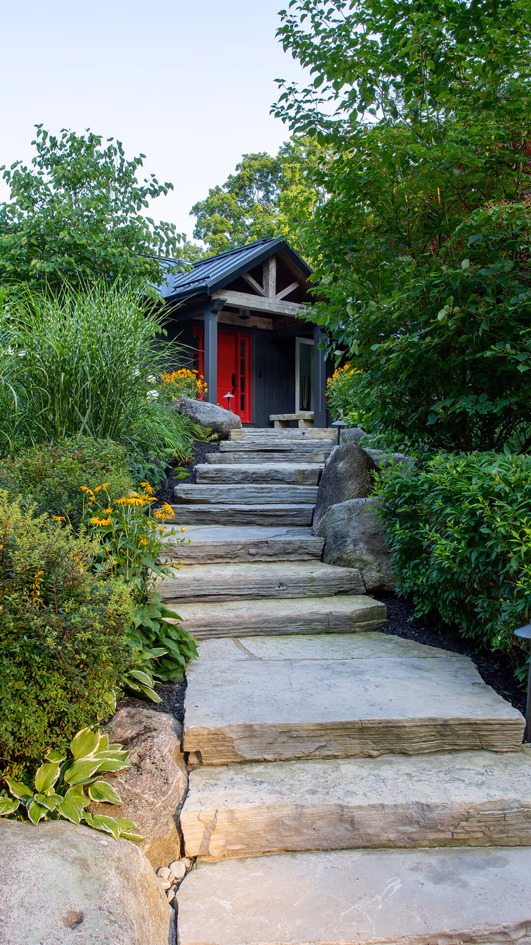 backyard landscaping with pool featureing waterfalls flowing into the pool, cabana with fireplace