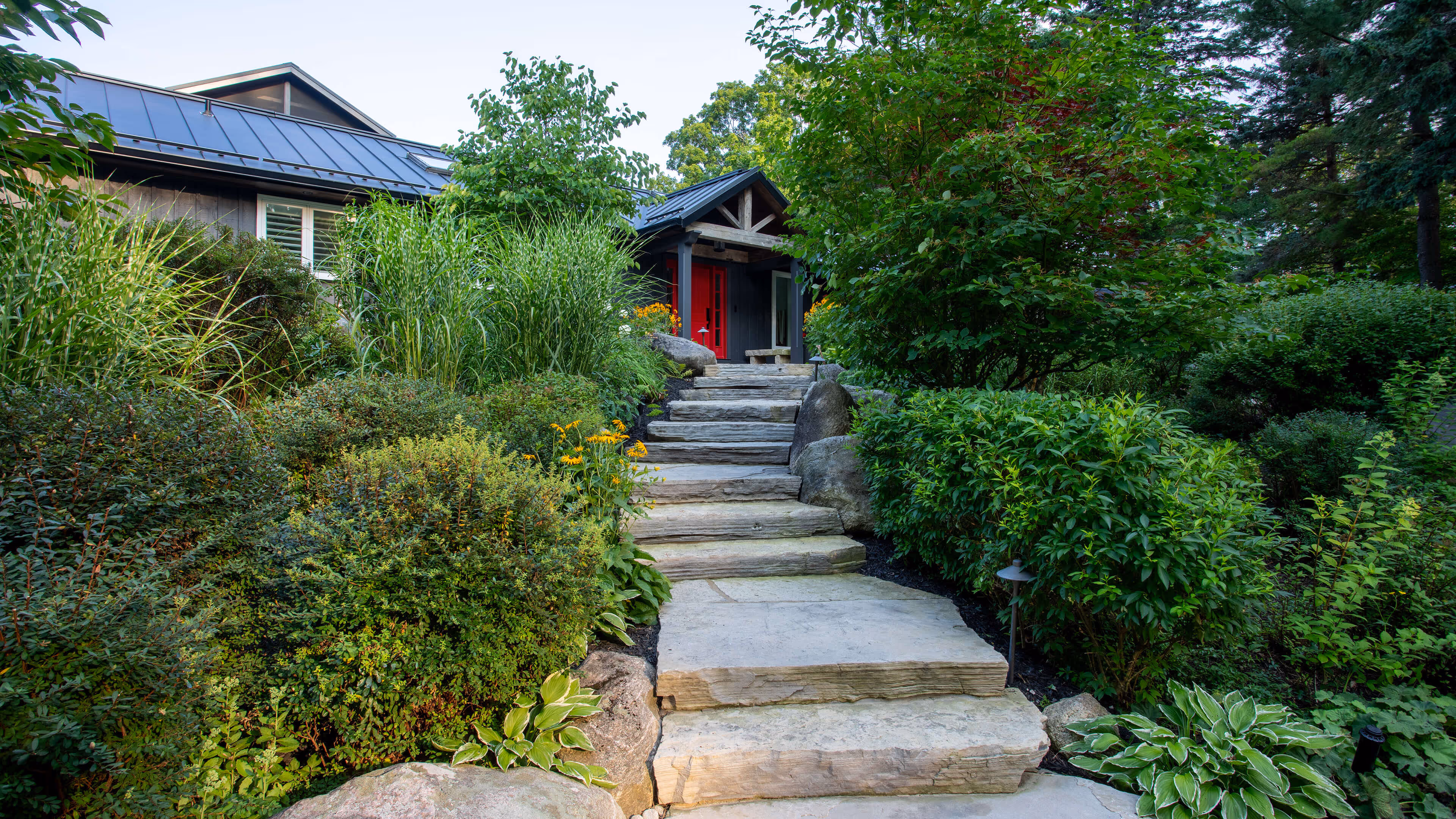 backyard landscaping with pool featureing waterfalls flowing into the pool, cabana with fireplace