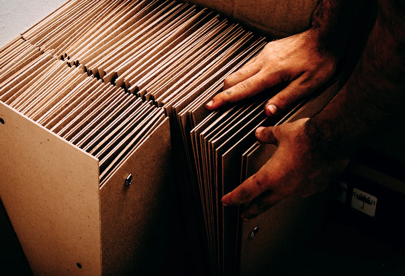 Hands sorting cardboard folders.