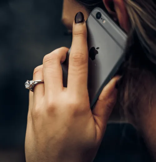 Woman holding a smartphone to her ear.
