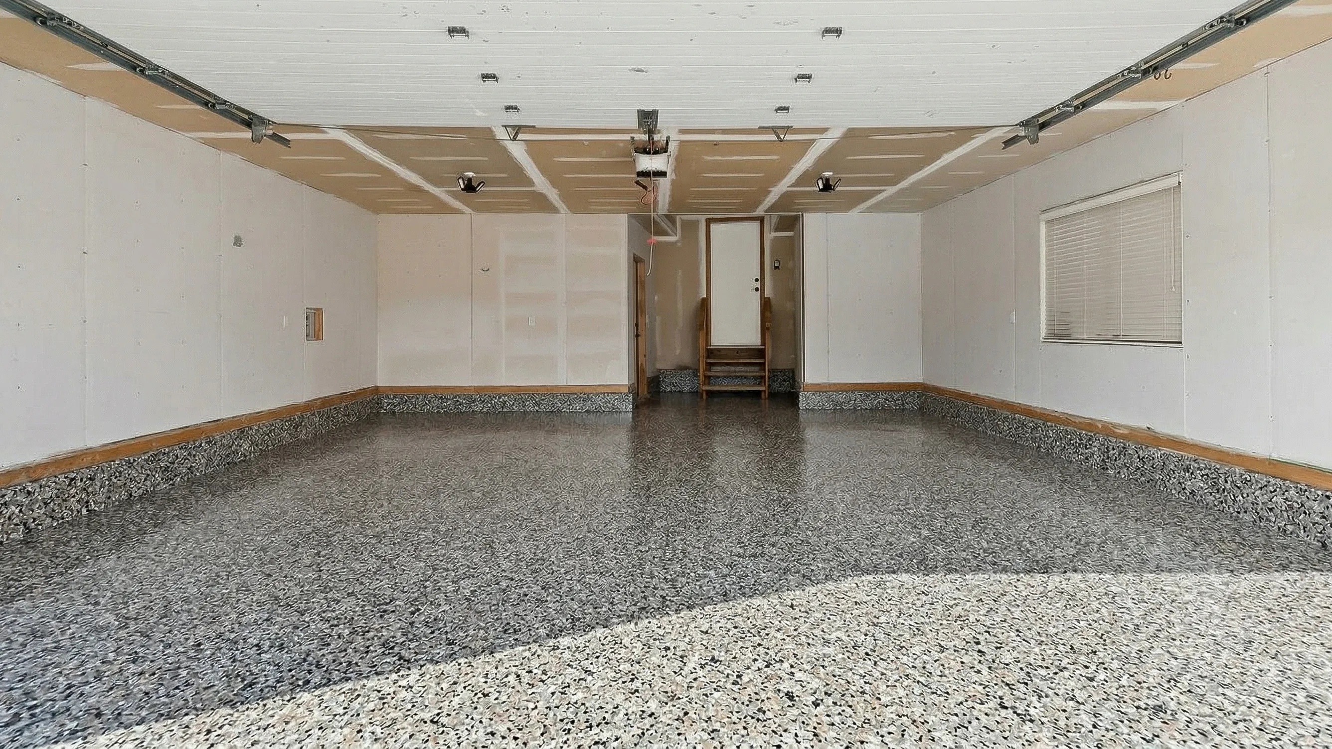 Completed flake epoxy garage floor in Arbour Lake Calgary by Epoxy Floors Canada