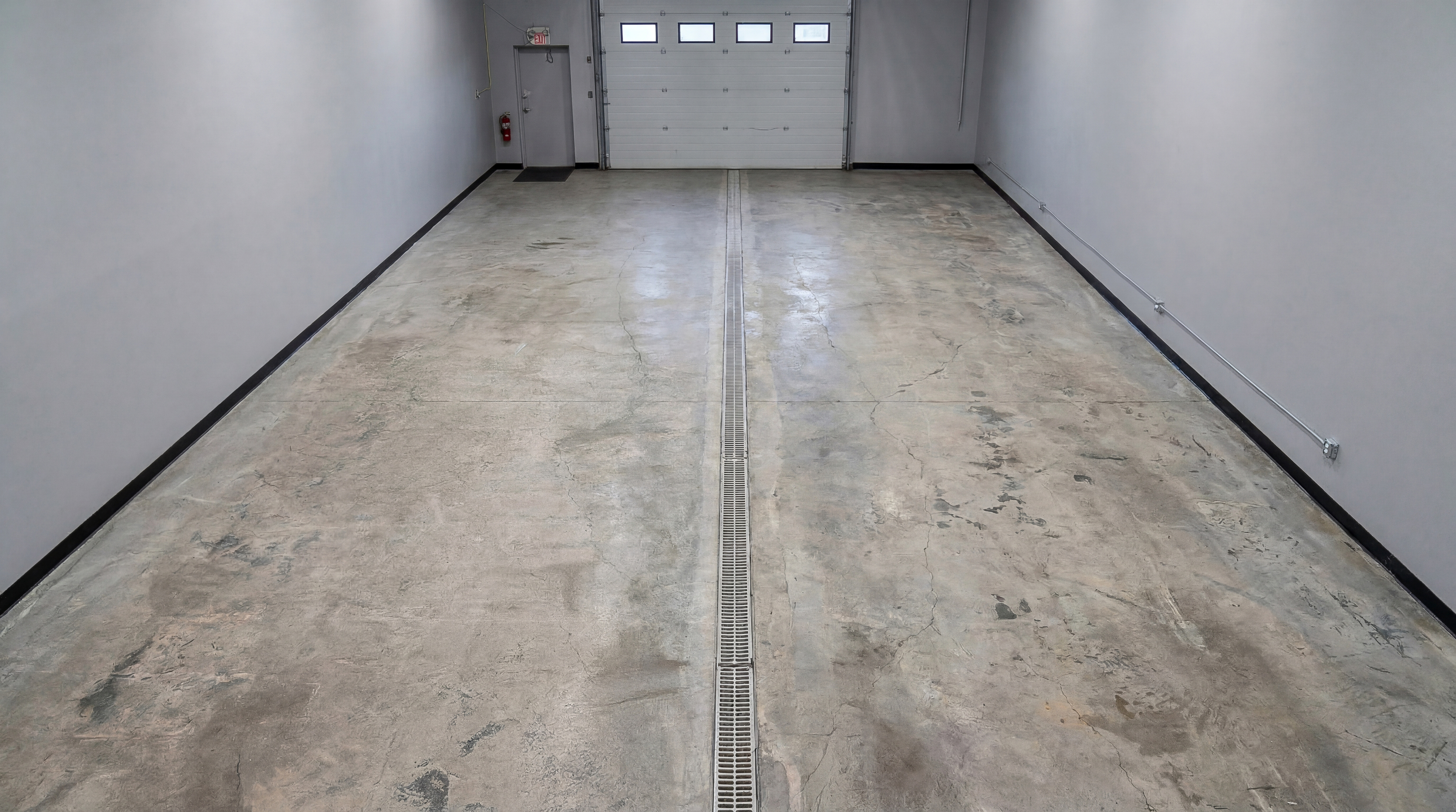 Before: bare concrete garage floor