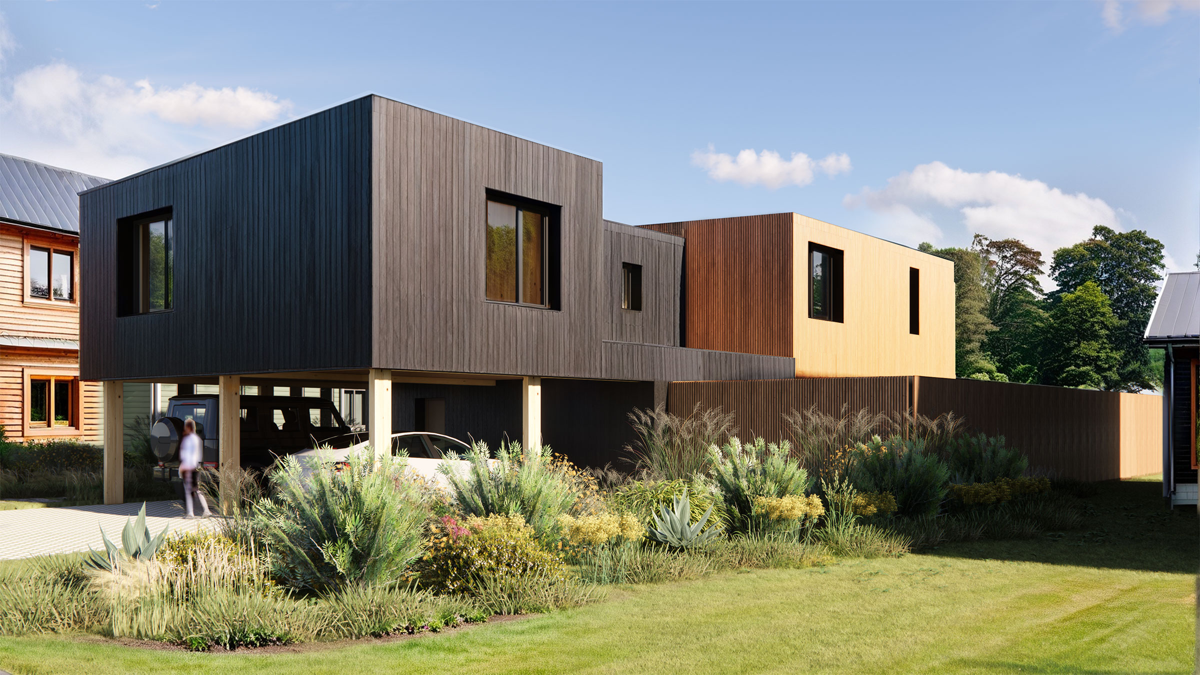 A home with a modern architectural look. The siding is all wood, with a darker tone in the front of the house contrasting with a lighter tone wood in the back.