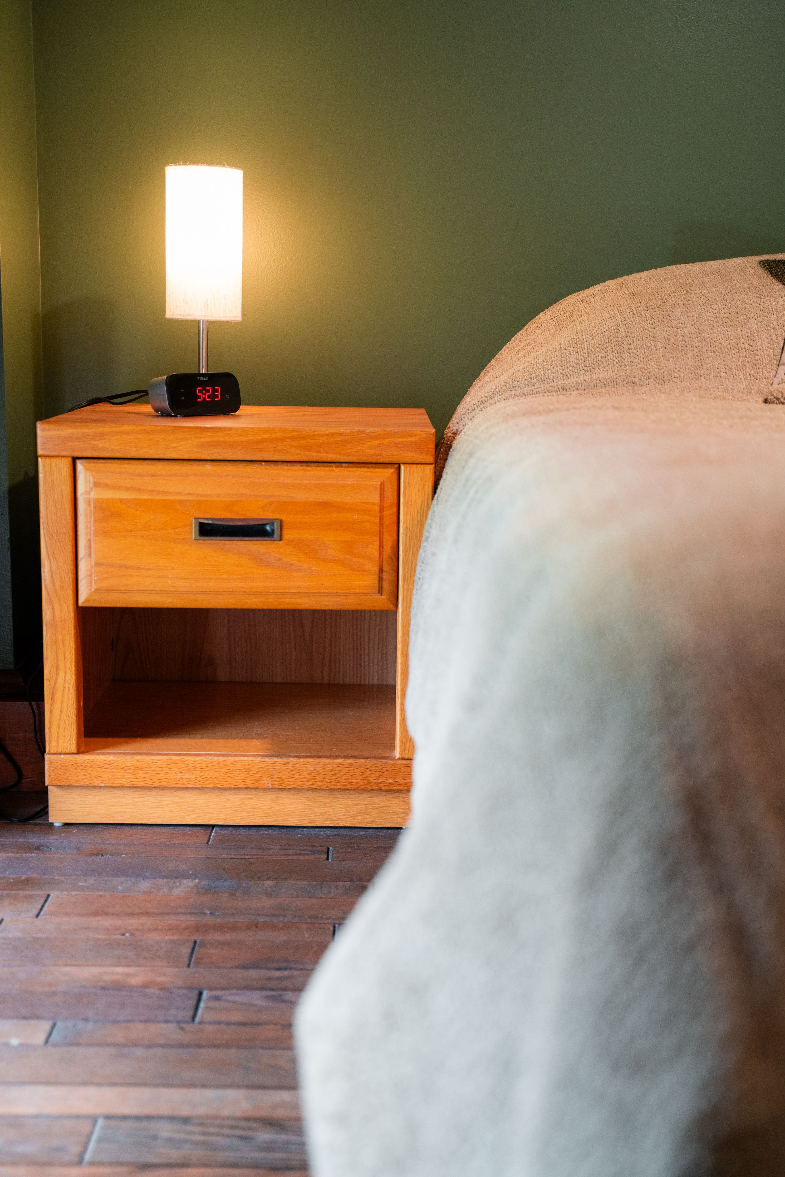 image of side of bed and nightstand