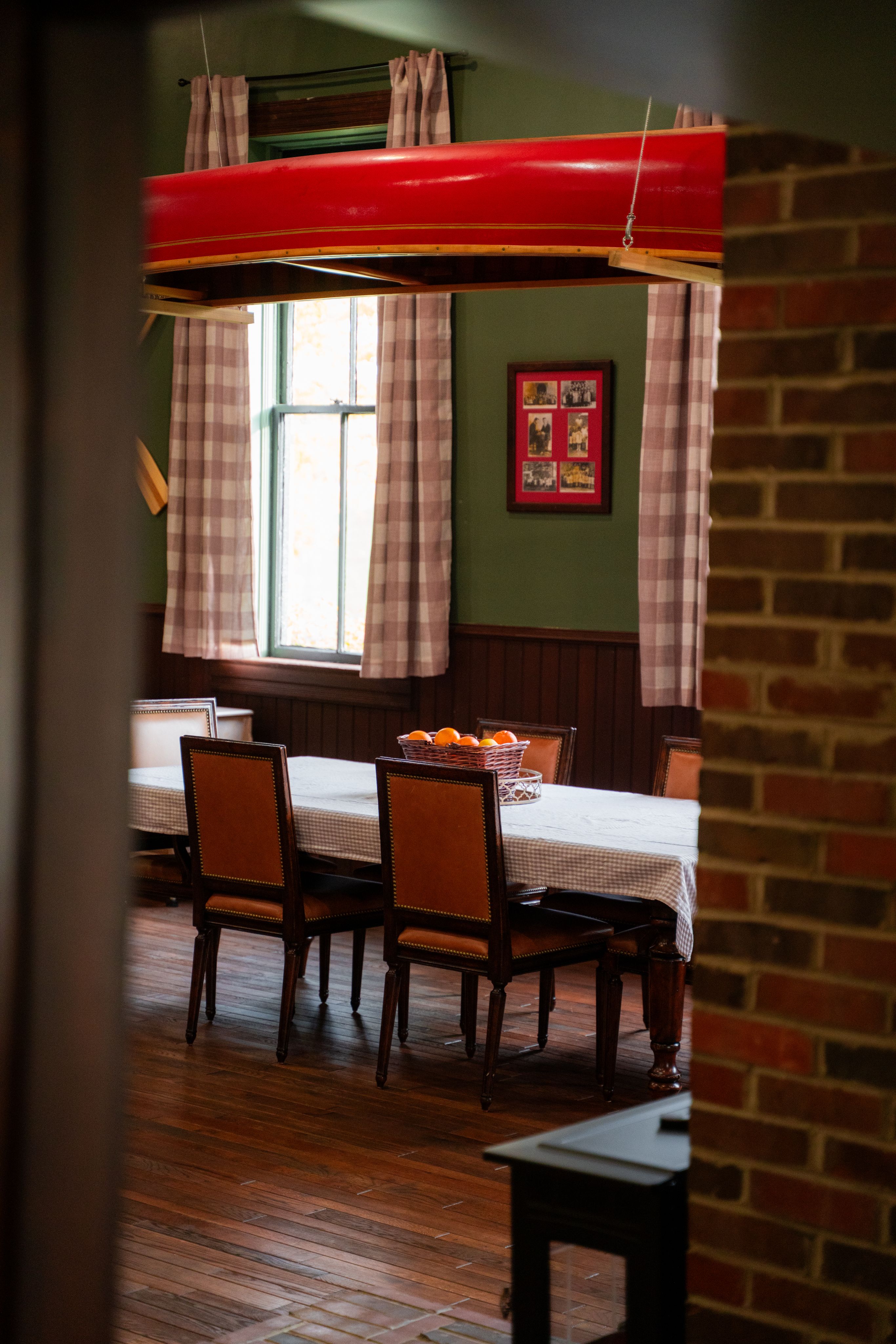 image of dinner table with canoe above