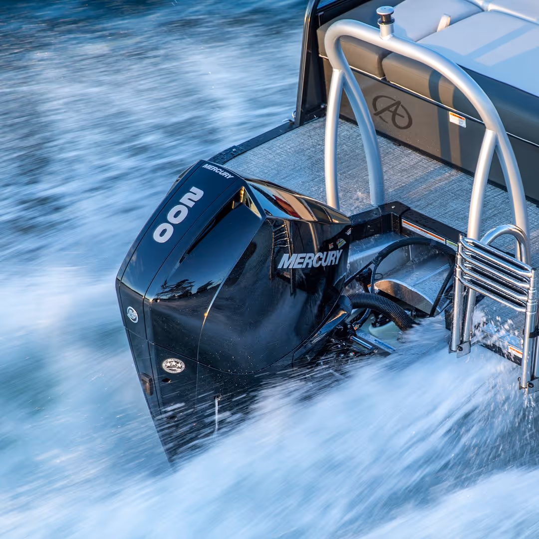 Close-up of a black Mercury 200 horsepower outboard motor attached to a boat moving through water.