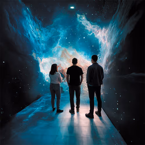 Three people standing on a reflective floor facing a large, illuminated cosmic or nebula-like digital display on the wall.