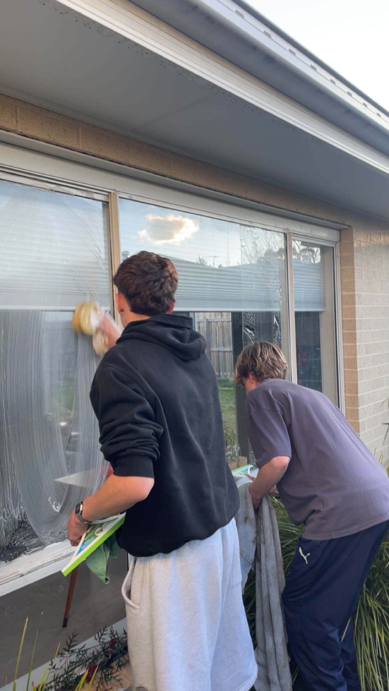image of team in front of company building (for a roofing contractor)