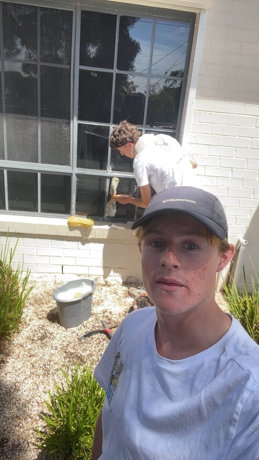 image of team in front of company building (for a roofing contractor)