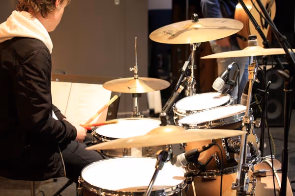 A young person drumming during worship at Canberra International Church. 