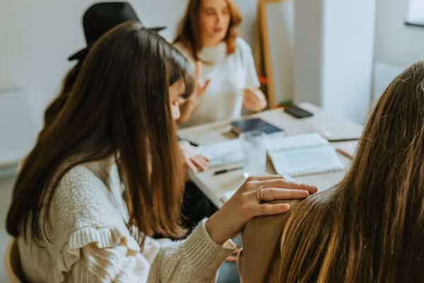A group of young people praying together.
