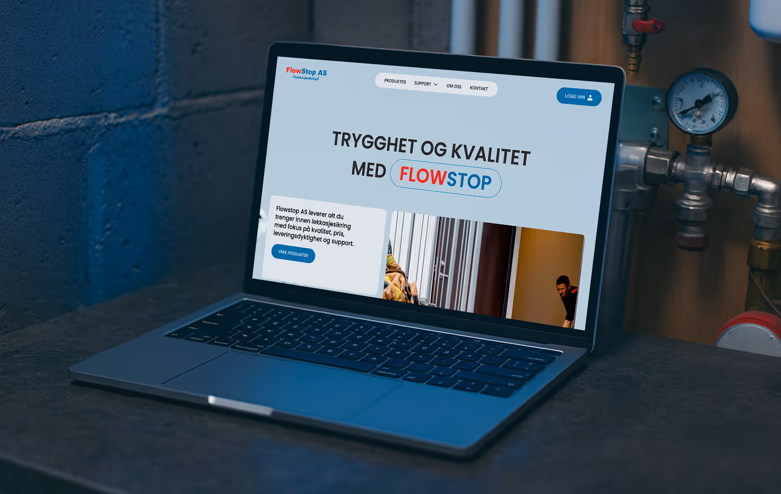 Laptop on a dark surface displaying a website homepage for FlowStop AS about leak protection and quality assurance.