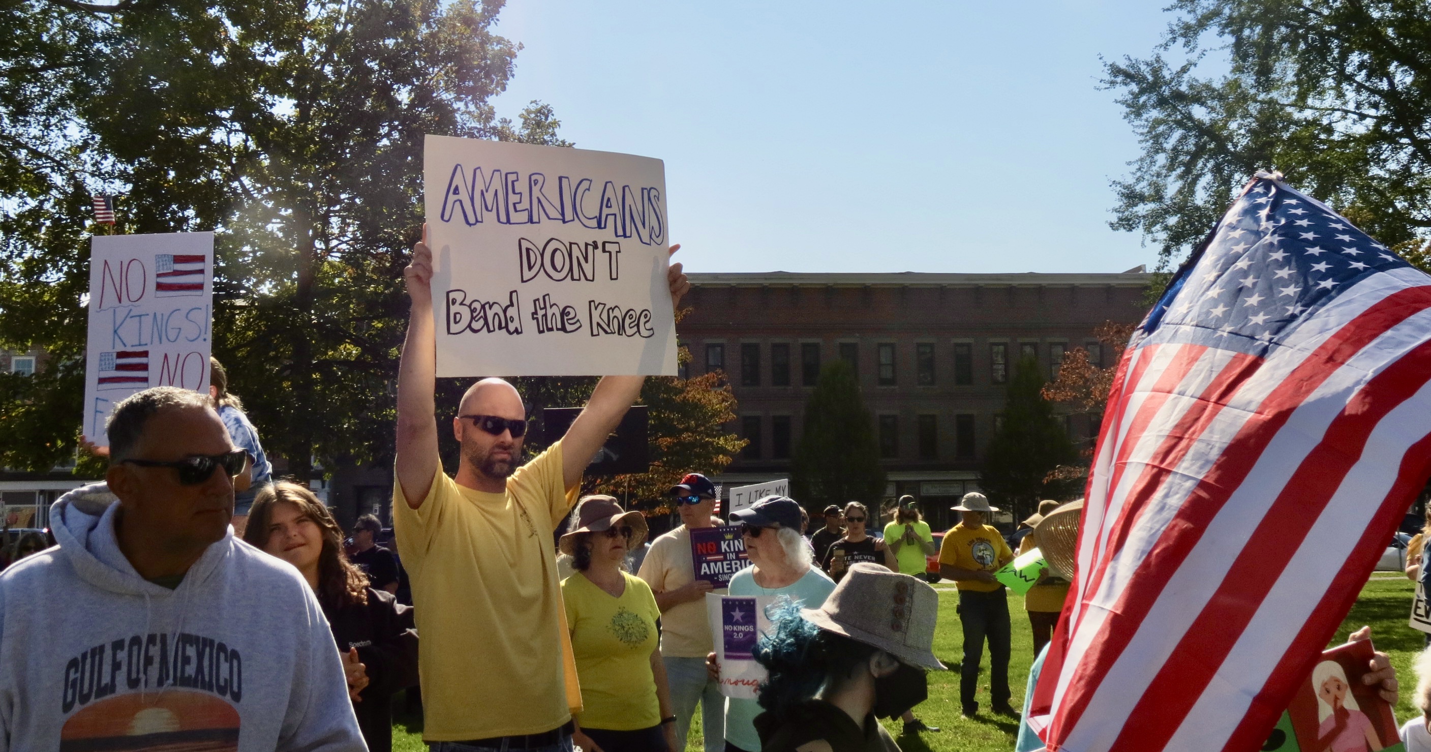A man holding up Americans dont bend the knee