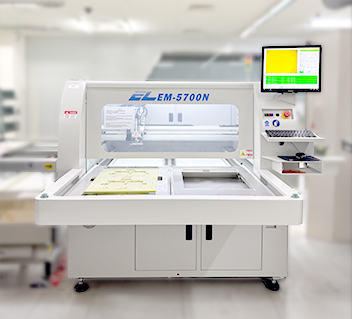 EM-5700N automated router machine with touchscreen monitor in a clean industrial workspace.