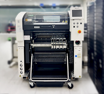 Front view of a modern automatic pick-and-place machine for electronic component assembly.