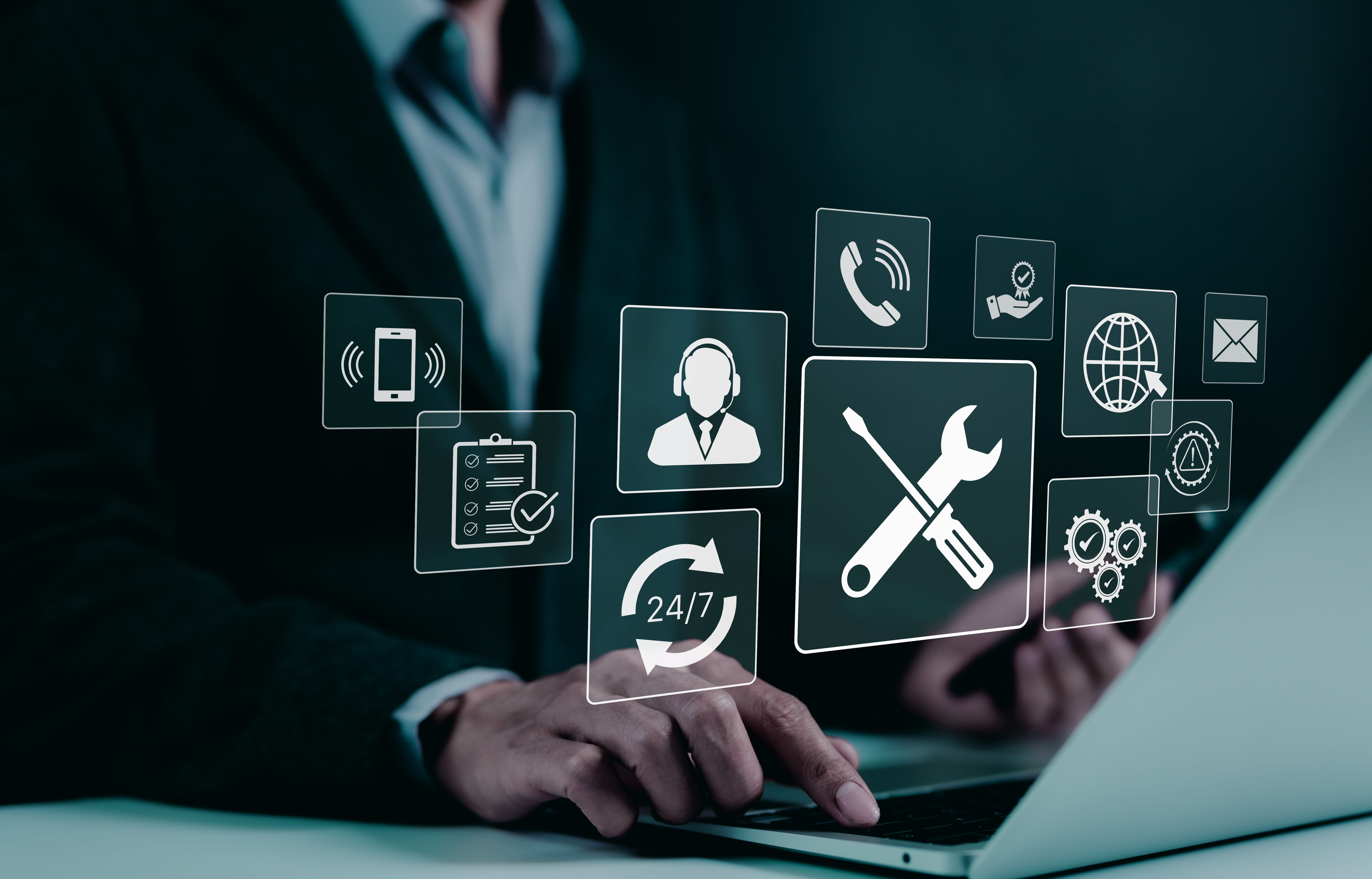 Person using laptop with floating icons representing technical support and 24/7 service.