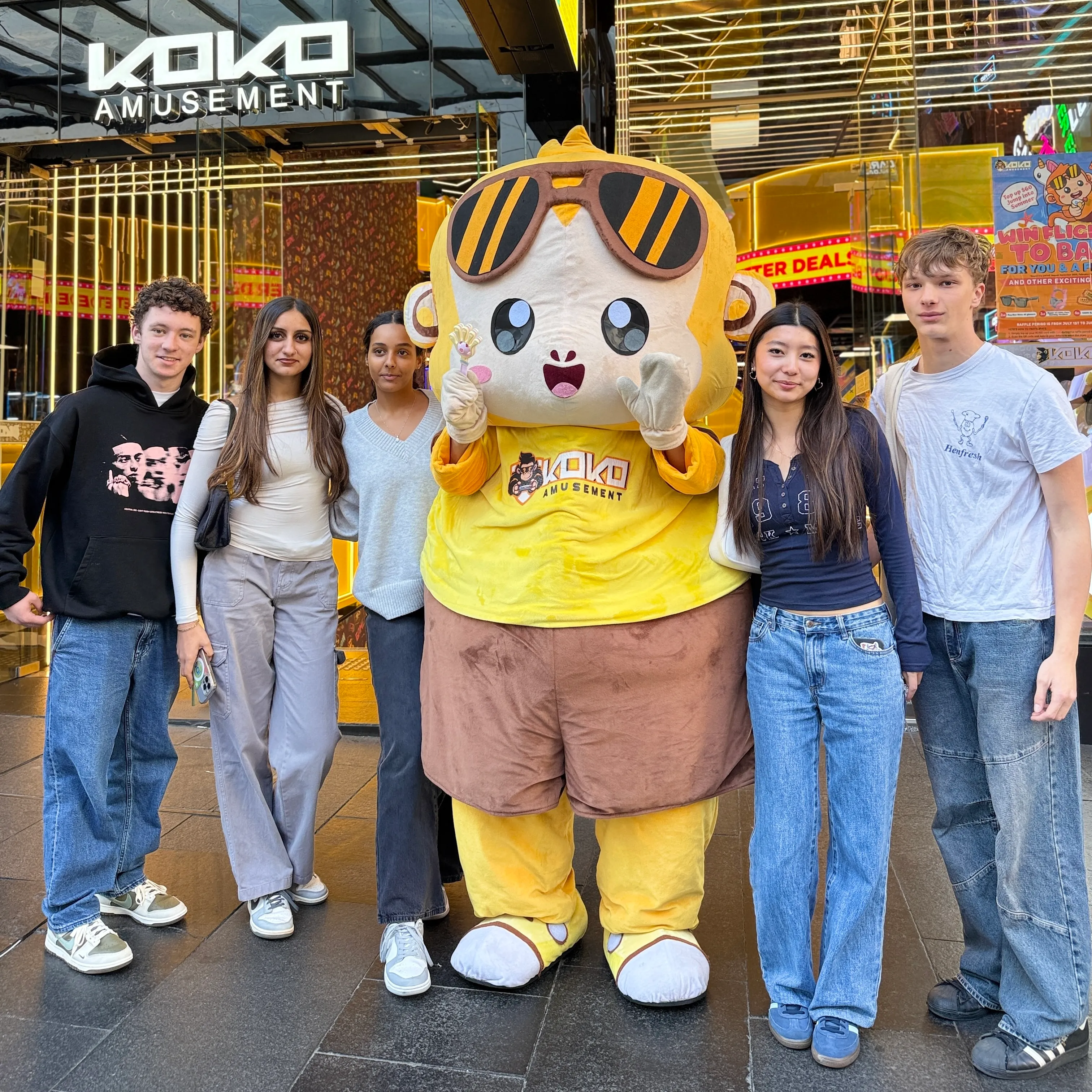 KOKO Amusement mascot with guests outside the Town Hall venue in Sydney